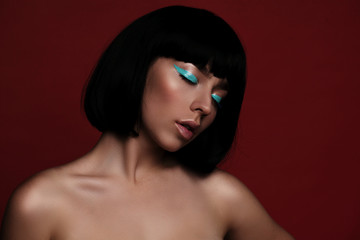 Fototapeta premium Close up portrait of fashion woman model with turquoise arrow