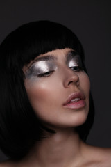 young brunette woman with shining silver makeup