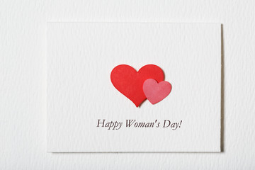 Happy Woman's Day white message card with red hearts