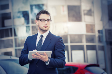 Businessman holding a digital tablet computer, standing in front