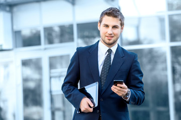 Attractive young businessman using a cell phone