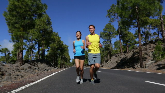 Running runner man and woman jogging