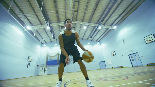 Slow motion basketball player dribbling the ball