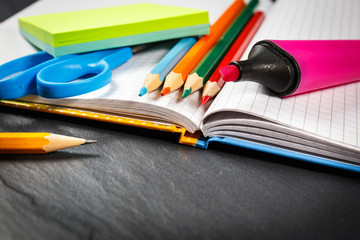 School supplies on black background