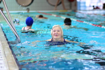 Healthy senior woman swimming in the pool