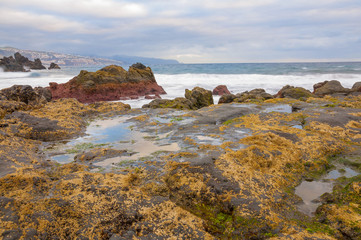 Sunrise on black sand volcanic beach. Tenerife