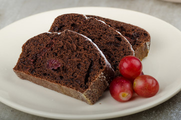 Fototapeta na wymiar Chocolate cake with strawberries and grapes