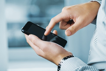 Close up of a man using mobile smart phone