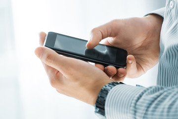 Close up of a man using mobile smart phone