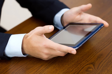 Businessman using tablet by the desk