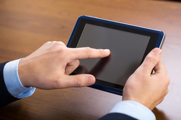 Businessman using tablet by the desk