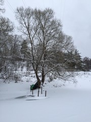 A lonely boat on a river in winter