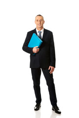 Mature businessman holding a binder