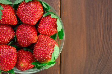 top view bowl of strawberries on wood