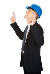 Businessman engineer pointing up