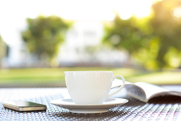 Coffee cup with book & mobile phone on the table