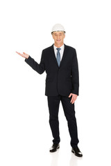 Businessman with hard hat holding copyspace