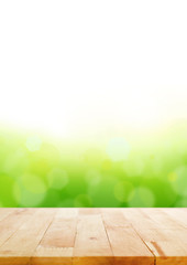 Wood table top on abstract white & green bokeh background