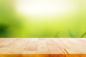 Wood table top on abstract nature green background