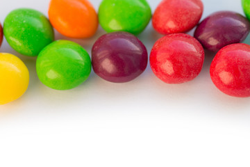 Colorful chewy dragee on a white paper.