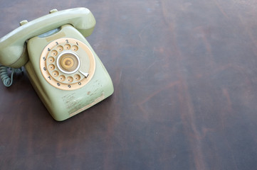 Old phone on leather background