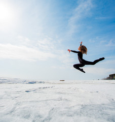 Fototapeta premium beautiful beautiful girl jumping in the snow