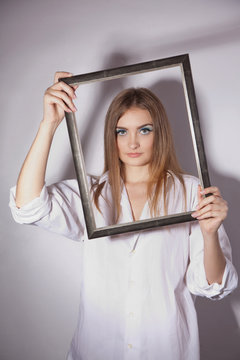 Sad woman holding a frame in his hands