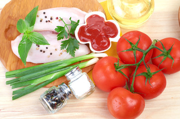 Raw chicken breasts on cutting board