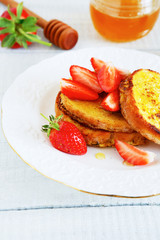 French toast with maple syrup and strawberries