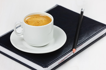 workplace with business diary, pencil and cup of coffee.