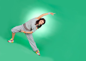 Fototapeta na wymiar Attractive young female in stretching over green