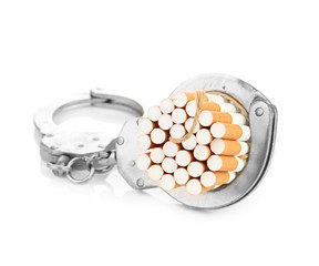 Addition concept with cigarettes and handcuffs