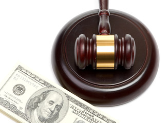 Law gavel on a stack of American money.