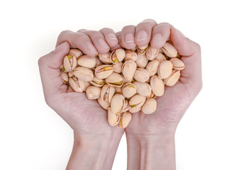 hands holding pistachios on isolated white background