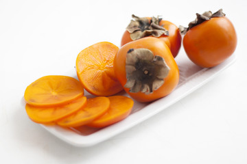 persimmons on white plate