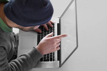 Hacker threatening to a victim over a laptop screen.