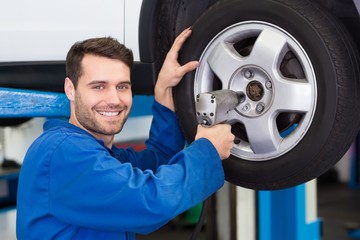 Mechanic adjusting the tire wheel