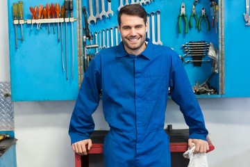 Smiling mechanic looking at camera