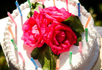 white creamy delicious cake with candles closeup