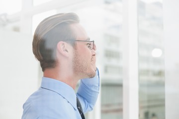 Businessman standing with glasses smiling