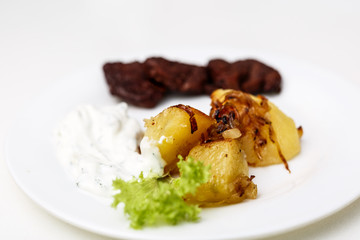 plate with beef and potatoes and gravy