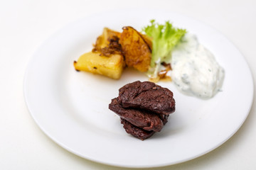 plate with beef and potatoes and gravy