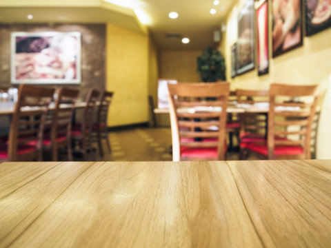Wooden Table top with Restaurant Background