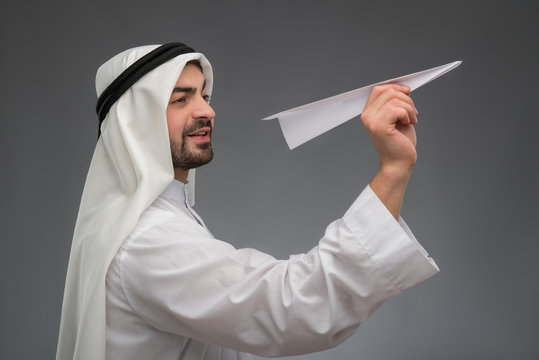 Arab businessman with paper airplane
