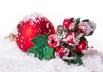 Fototapeta na wymiar Christmas ball in the snow with rowan