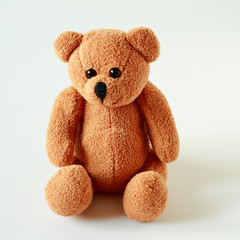 Old patched brown teddy bear