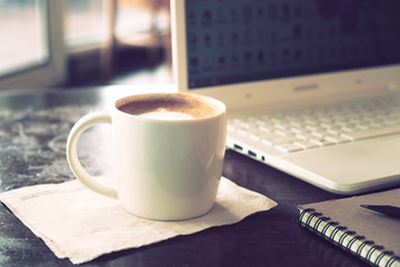 vintage color tone of  cup of coffee  on the table coffee shop