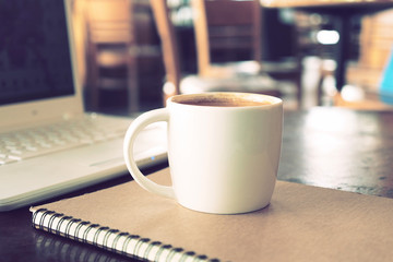 vintage color tone of  cup of coffee  on the table coffee shop
