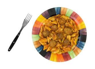 Cooked meatballs and pasta meal with a fork on a colorful plate