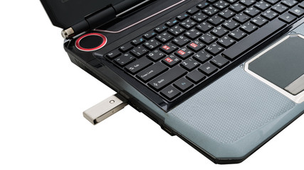 Flash memory drive plugged into a laptop port.